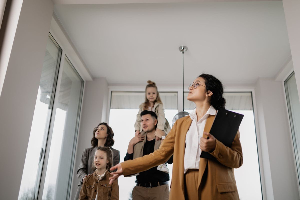 An agent showing a family through a home